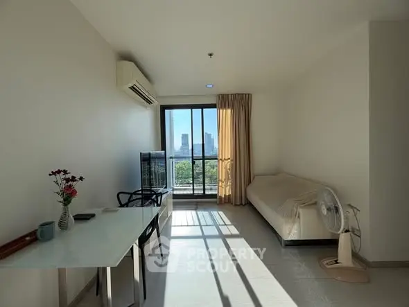 Bright living room with city view, modern furniture, and natural light.