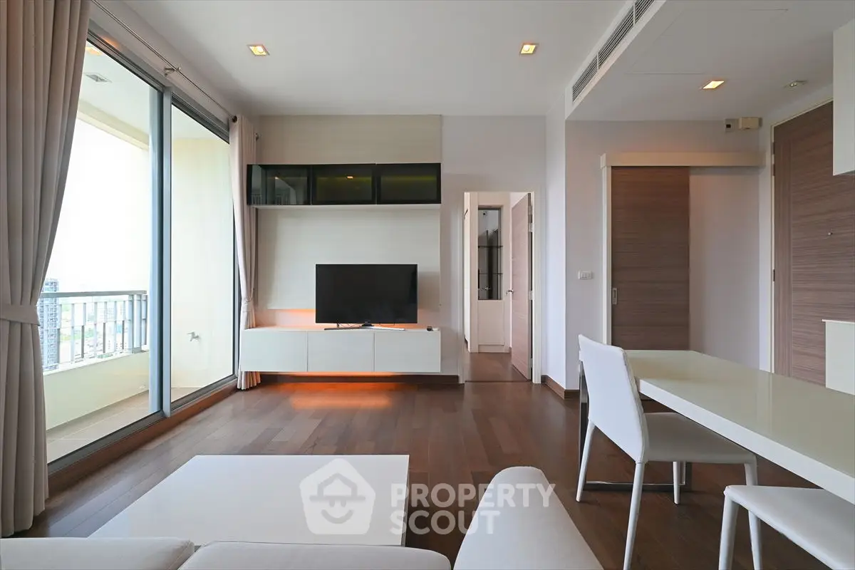 Modern living room with balcony view and sleek furniture design