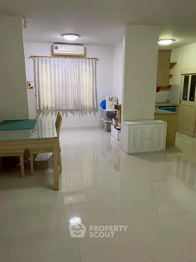 Spacious dining area with modern kitchen in open layout apartment.