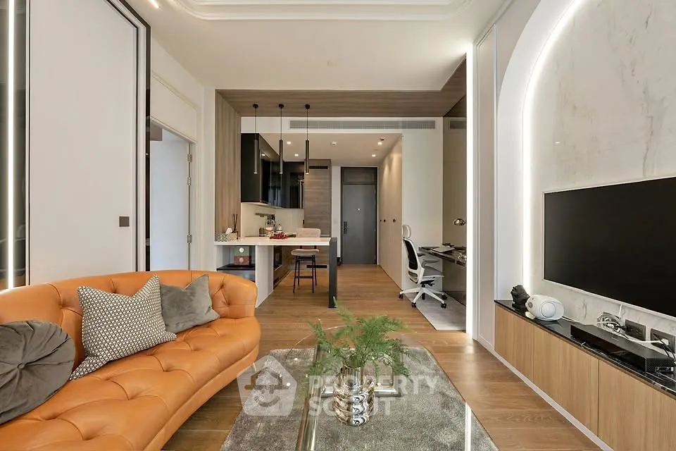 Modern open-plan living room with stylish decor and sleek kitchen area