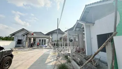 Newly constructed modern houses in a serene neighborhood with clear skies.