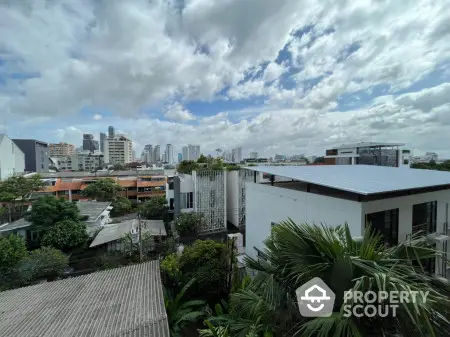 Stunning cityscape view from modern residential rooftop with lush greenery and skyline