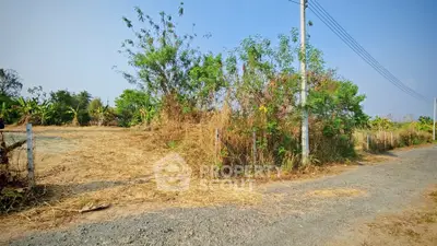 Spacious land plot with lush greenery and clear blue sky, perfect for development opportunities.