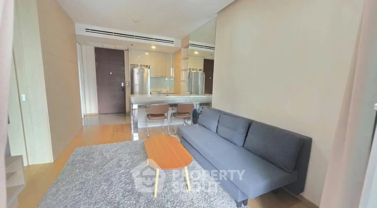 Modern living room with sleek furniture and open kitchen layout