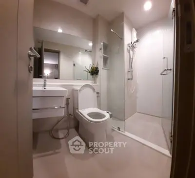 Modern bathroom with glass shower and sleek fixtures