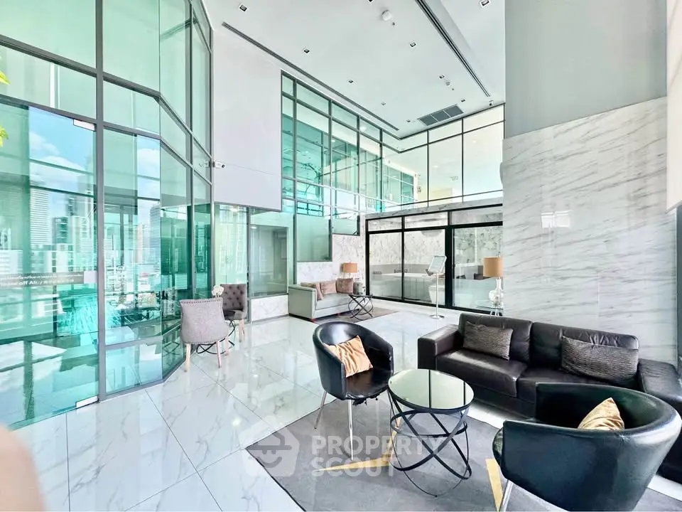 Luxurious modern living room with high ceilings and glass walls in a contemporary apartment.