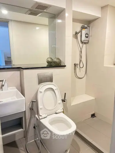 Modern bathroom with shower and sleek fixtures in a contemporary home.