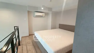 Modern bedroom with minimalist design and air conditioning in a stylish apartment.