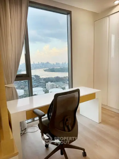 Modern study room with stunning city view from high-rise window, featuring sleek desk and ergonomic chair.
