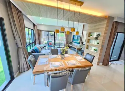 Spacious modern living and dining area with elegant decor and large windows.