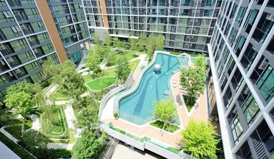 Luxurious modern apartment complex with stunning pool and lush garden view.