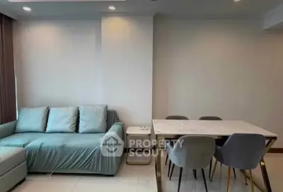 Modern living room with stylish sofa and elegant dining table in a cozy apartment.