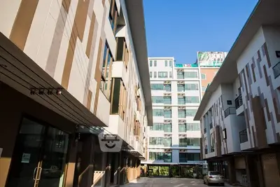 Modern apartment complex with unique facade design and clear blue sky