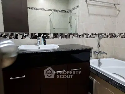 Modern bathroom with elegant fixtures and stylish tile accents