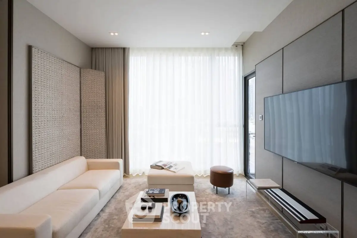 Luxurious modern living room with elegant decor and large TV, perfect for relaxation and entertainment.