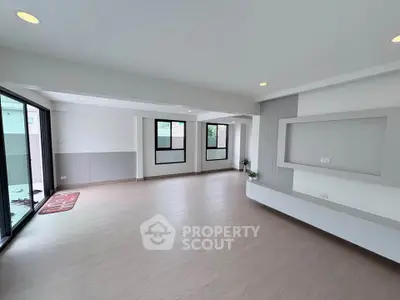 Spacious modern living room with large windows and sleek flooring