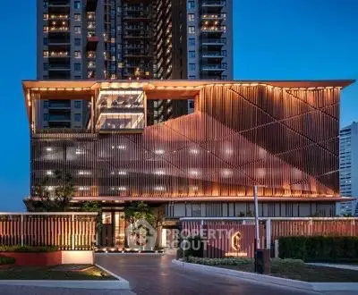 Stunning modern building exterior with unique architectural design and elegant lighting at dusk.