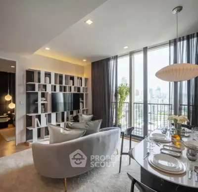 Modern living room with city view, elegant decor, and open dining area in a high-rise apartment.
