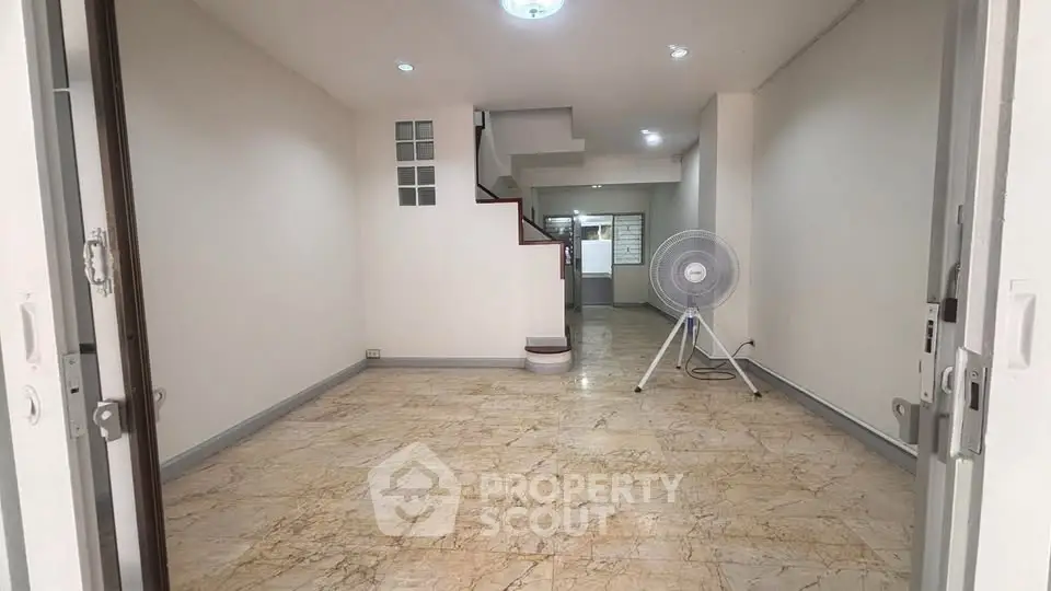 Spacious open-plan living area with marble flooring and modern lighting, perfect for customization.