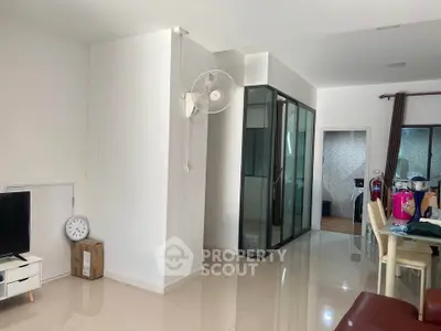 Spacious modern living area with sleek design and ample natural light, perfect for comfortable living.