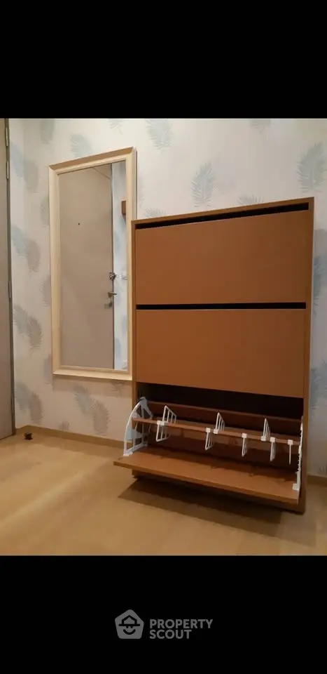 Modern entryway with shoe storage and mirror, perfect for organizing and enhancing small spaces.