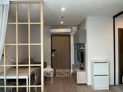 Modern living room with wooden accents and sleek furniture in a cozy apartment.