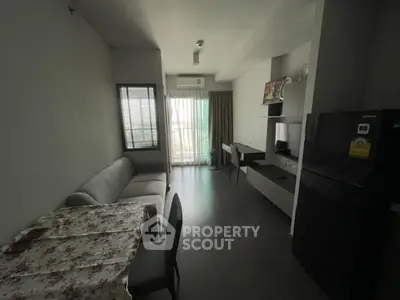 Cozy living room with dining area and modern appliances in a stylish apartment.