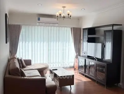 Cozy living room with modern furniture and large window for natural light.