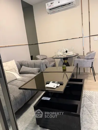 Modern living room with stylish furniture and dining area in a cozy apartment.