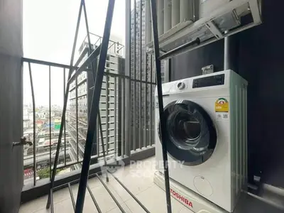 Modern balcony with washing machine and city view, perfect for urban living.