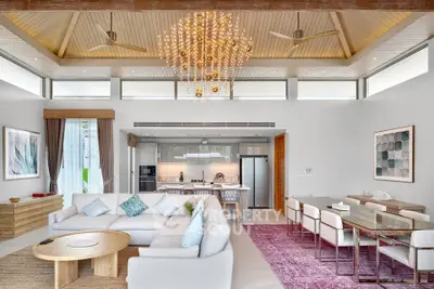Luxurious open-plan living room with modern kitchen, elegant chandelier, and stylish decor