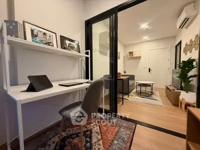 Modern apartment with study area and cozy living room, featuring stylish decor and efficient use of space.
