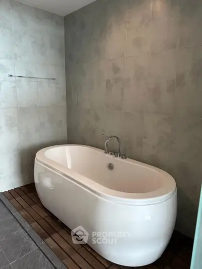 Luxurious bathroom with modern freestanding bathtub and elegant tile design.