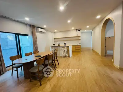 Spacious modern living room with wooden flooring and elegant dining area