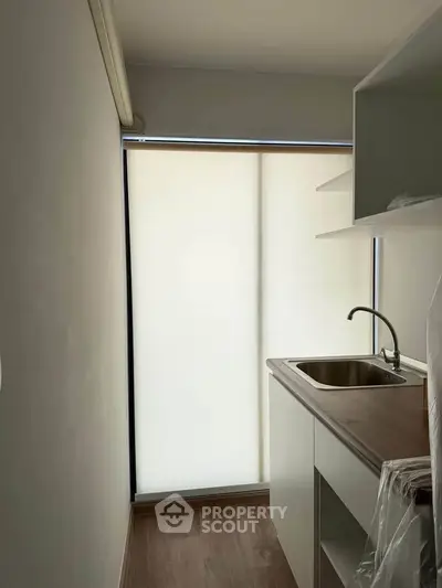 Compact kitchen with sleek design and natural light