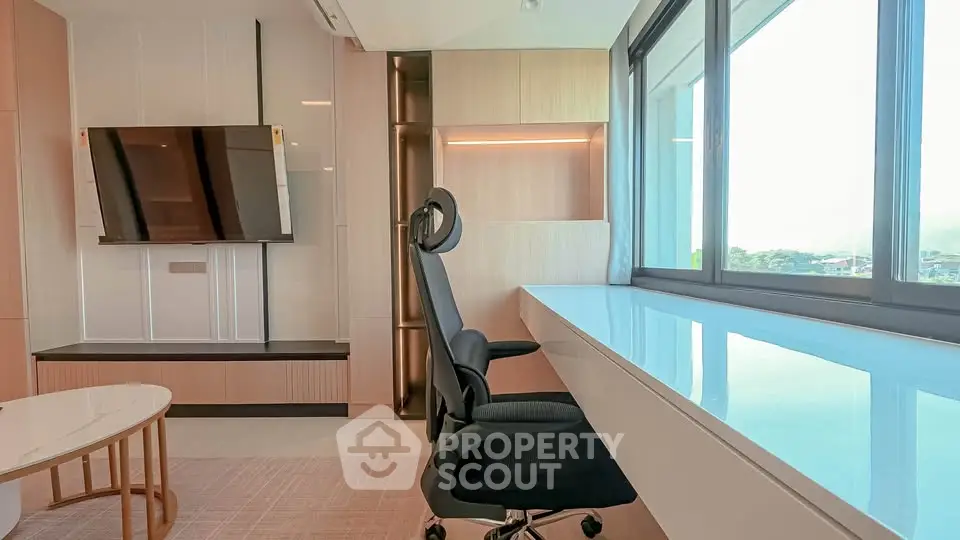 Modern study room with sleek desk and ergonomic chair, large window offering natural light and scenic views.