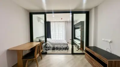 Modern apartment with glass partitioned bedroom and stylish wooden furniture