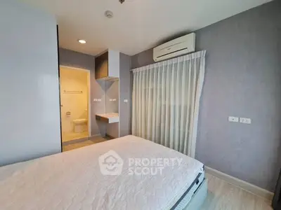 Modern bedroom with ensuite bathroom and air conditioning in stylish apartment