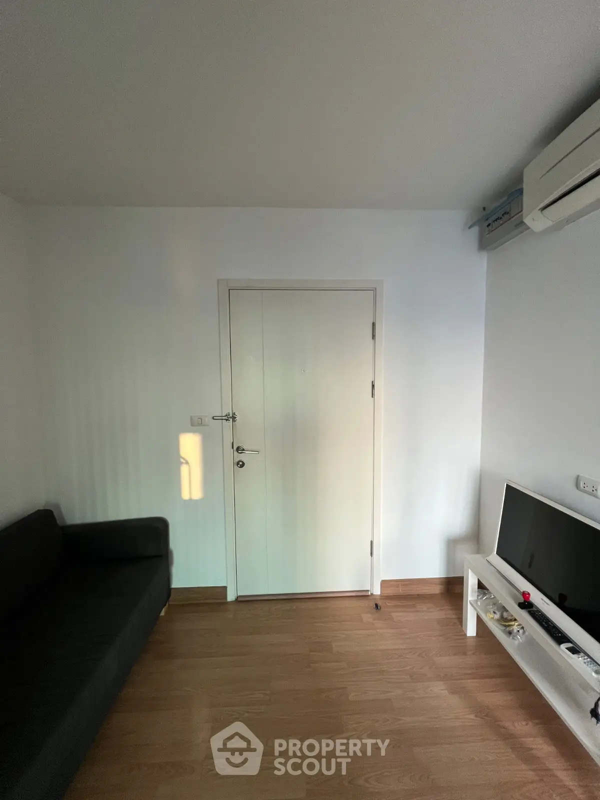 Cozy living room with modern air conditioning and sleek furniture.