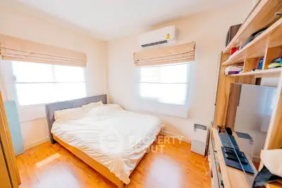 Cozy bedroom with wooden flooring and natural light
