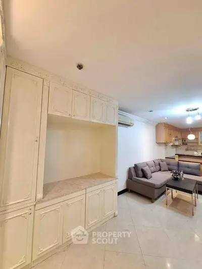 Spacious living room with elegant cabinetry and cozy seating area