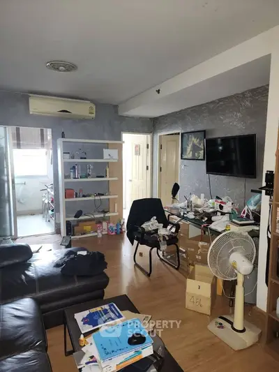 Spacious living room with modern decor and ample natural light.