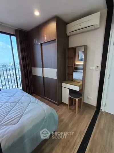 Modern bedroom with city view, featuring built-in wardrobe and air conditioning.