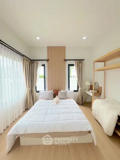 Bright and cozy bedroom with modern decor and natural light.