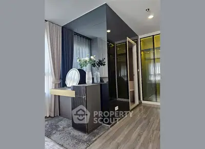 Modern bedroom with sleek design and elegant decor featuring a stylish vanity and large mirrored wardrobe.