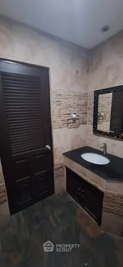 Modern bathroom with stylish tile design and sleek sink area