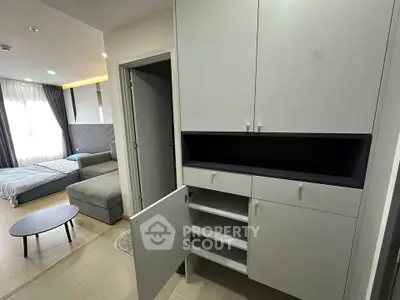 Modern apartment interior with sleek storage and cozy living area