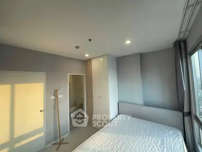 Bright bedroom with large windows and ensuite bathroom in modern apartment