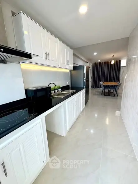 Modern kitchen with sleek white cabinets and open layout design