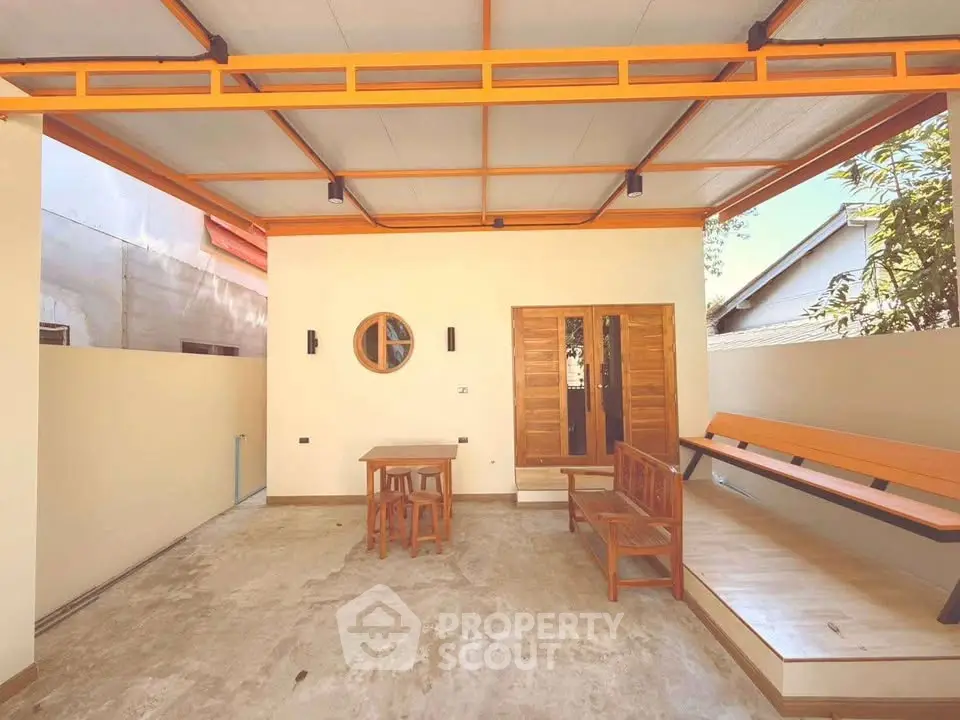Charming outdoor patio with wooden furniture and modern design, perfect for relaxation and entertaining.